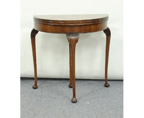 A walnut half-round card table on cabriole legs, 82cm wide