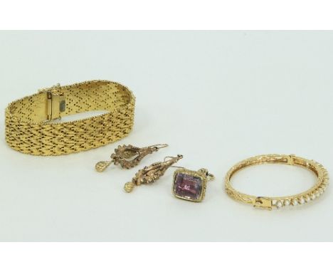 A pearl set hinged bangle with engraved sides, a pair of pendant earrings, a fob seal and an articulated bracelet