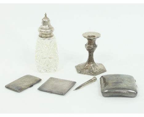 A silver candlestick, Birmingham 1909, two cigarette cases, a silver mounted caster, a compact and a silver plated propelling