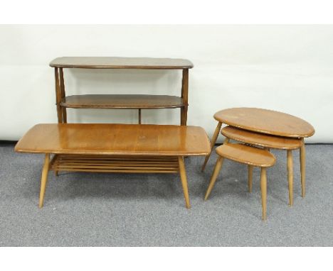 A nest of three Ercol oval shaped coffee tables on turned splay legs, 65cm wide, a rectangular Ercol table, 107cm and an Erco