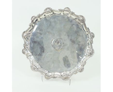 A George II silver salver, Ebenezer Coker, London 1759, with pie-crust edge on scroll feet, 29cm diameter, approximately 720g