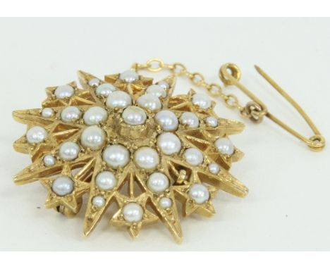 A split pearl starburst brooch set in 9ct gold and with safety chain