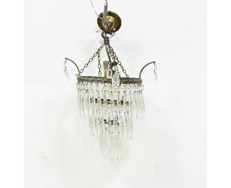 A three-tier hanging glass light fitting, hung with prismatic drops and another light fitting