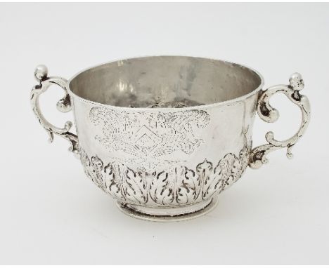 A Charles II silver porringer, maker's mark IH above fleur de lis, London 1677, with band of stiff leaf decoration, with cont