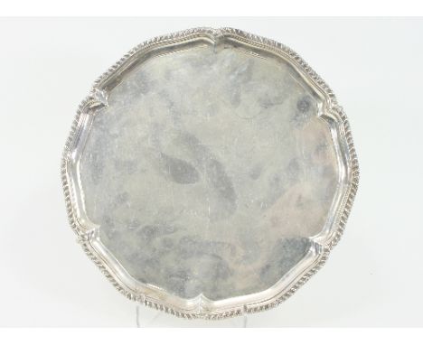 A George III silver salver, John Fountain, London 1792, with gadrooned rim, erased crest to centre, 30cm diameter, approximat