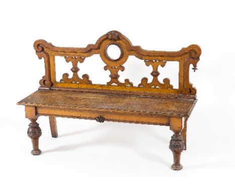 A oak hall bench with open Gothic style back on turned and carved front legs, 128cm wide/see illustration