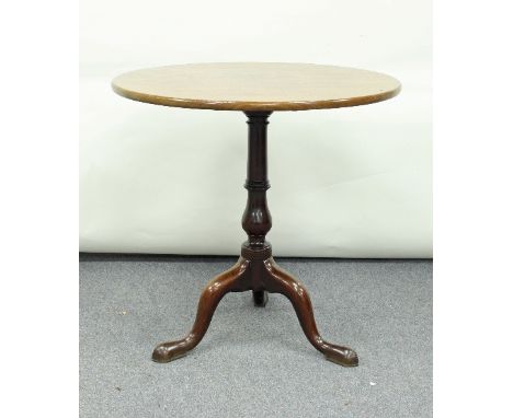 A George III mahogany supper table, the tip-up top on a turned column and tripod base, 72cm diameter