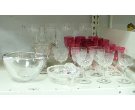 A circular Orrefors bowl, 16cm diameter, a Steuben bowl with stylised handle, thirteen stem glasses with cranberry bowls, two