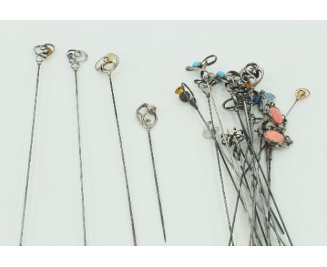 A collection of Charles Horner silver hat pins, one decorated with blue and green enamel, one 9ct gold scroll, many decorated