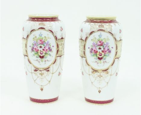 A pair of Noritake baluster vases, decorated bouquets of flowers within oval reserves, maroon borders, highlighted in gilt, 2