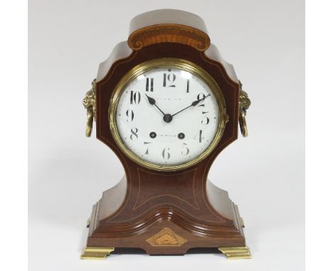 An Edwardian inlaid cased mantel clock, the white enamel dial with Arabic numerals signed Simmons, Cheltenham, the movement m