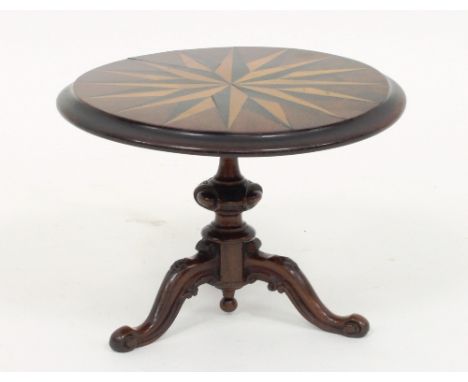 A Victorian mahogany and inlaid apprentice table, the circular top with sunburst inlay on a turned carved column and tripod b