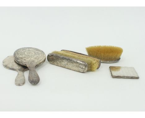 A silver cigarette case, Birmingham 1926, initialled and inscribed, and five silver backed dressing table items including two