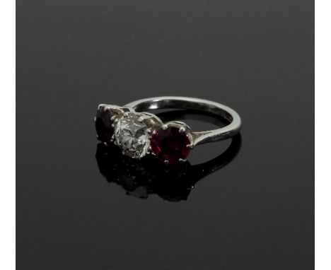 A three-stone ruby and diamond ring, claw set with a brilliant cut diamond and two circular cut rubies/see illustration