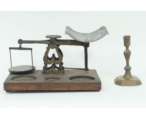 An early 18th Century brass candlestick of baluster form engraved with floral scrolls and a set of scales/Provenance: Plas Gw