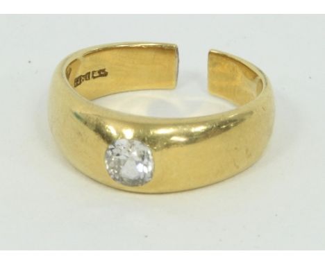 A single-stone diamond ring, set in 18ct gold, the shank cut