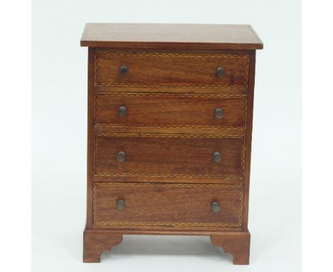 An Edwardian mahogany apprentice chest, fitted four long drawers on bracket feet, the top and drawer fronts with chequer band