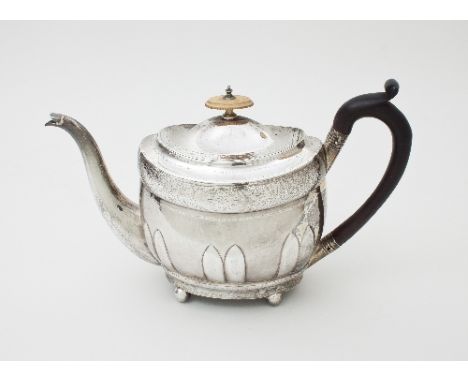 A Scottish silver teapot, McHattie & Fenwick, Edinburgh 1804, of oval shape with embossed lappets to the sides, fitted an ebo