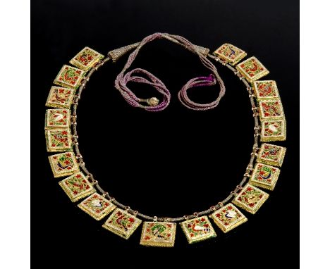 An antique Indian necklace, 19th Century, graduated with twenty rectangular plaques of polychrome red, green, white and blue 