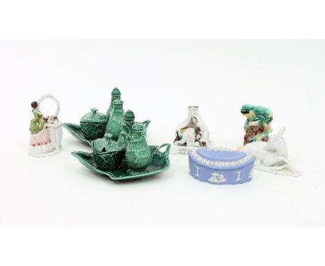 Two Wedgwood leaf-shaped cruet stands, each with three cruets, a jasperware trinket box, a fairing, a Rosenthal figure of a r