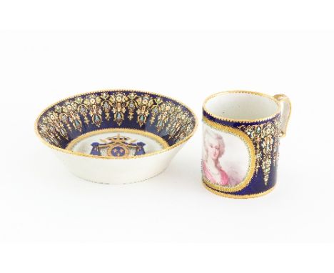 A large Sèvres style cup and saucer, mid 19th Century, with jewelled arabesques to the cobalt blue borders, the cup with port