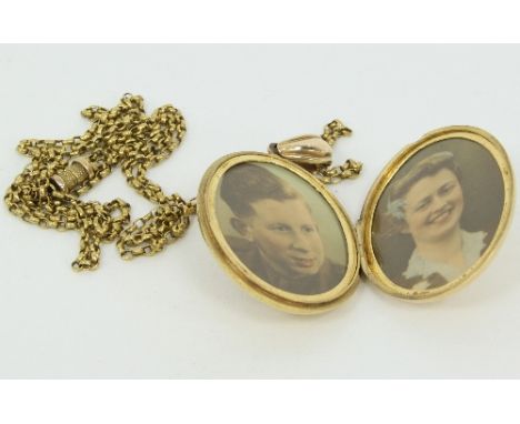 A Victorian gold and gem set locket, the oval shaped large locket with a cushion shaped ruby set to the centre, within a blac