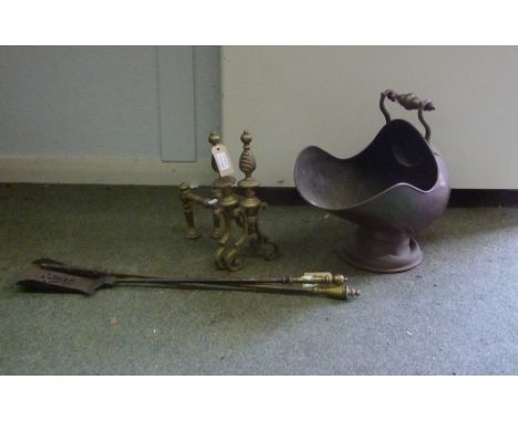 A 19th Century copper helmet shaped coal scuttle with swing handle, a pair of rests and two fire irons