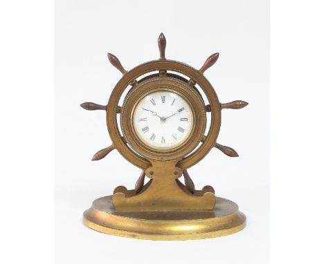A late Victorian gilt brass mantel clock, modelled as a ship's wheel, fitted a white enamel dial with Roman numerals, 19.5cm 