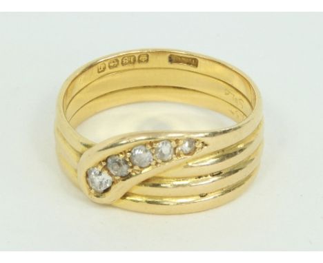 An 18ct gold and diamond snake ring, claw set with a line of circular cut diamonds to the head, marked 18ct, ring size V
