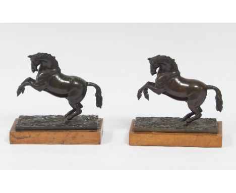 A pair of bronze rearing horses on rectangular bases, 9cm wide/Provenance: Chambers Court, Gloucestershire