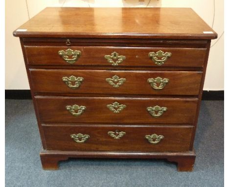 A late 18th Century mahogany chest, the rectangular top with moulded border, fitted a brushing slide and four graduated drawe