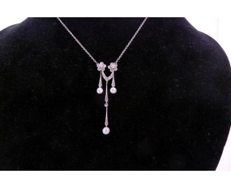 A diamond pendant necklace, of two flowerhead clusters suspending three drops, on a fine link necklet, a pair of diamond clus