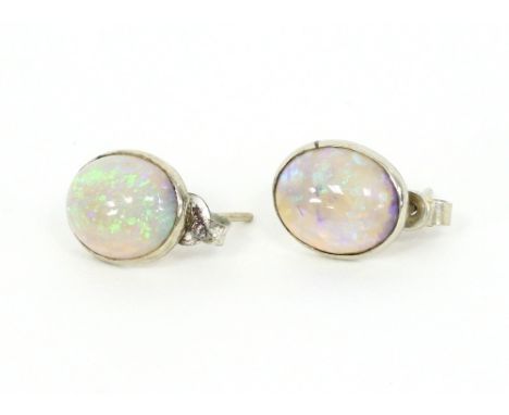 A pair of oval opal earrings in a box