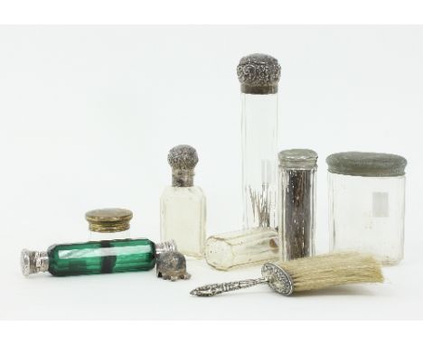 A green glass double-ended scent bottle, the faceted green glass bottle with engraved white metal mounts, two silver mounted 