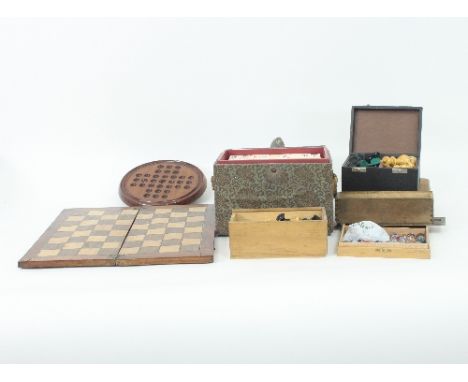 A boxwood and ebonised chess set, the folding board for the same and sundry games