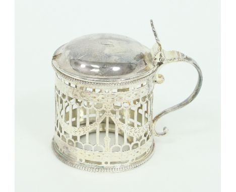 A George III silver mustard pot, Thomas Daniel, London 1777, with beaded borders and pierced sides decorated swags
/Provenanc