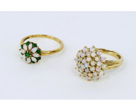 An opal petal ring and another set with opals and emeralds