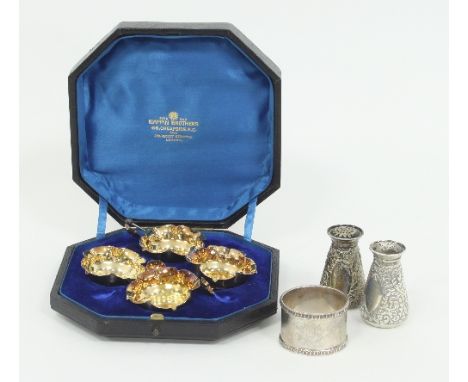 A set of four silver and silver-gilt open salts, London 1892, of quatrefoil shape with the matching spoons, boxed, a pair of 