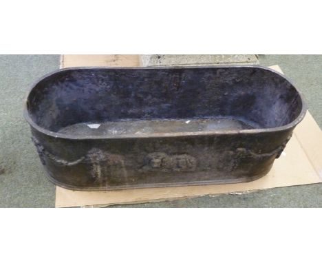 An oval lead planter with swags to the ends and a recumbent lion to each side, 77cm long