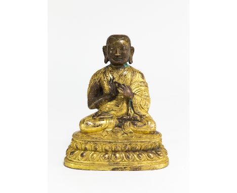 A bronze parcel gilt figure of the seated Buddha, 22cm high/see illustration