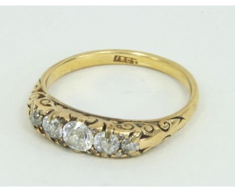 A five-stone diamond ring, the graduated stones in a scroll setting to an 18ct gold shank, ring size Q