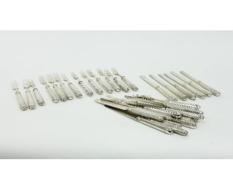 A matched set of eighteen dessert knives and forks with silver handles and blades, some with crests to handles/Provenance: Ch