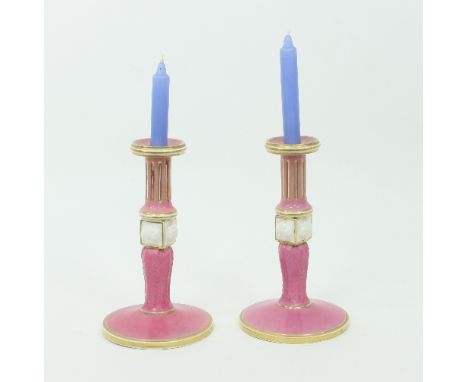 A pair of Bloor Derby candlesticks, with fluted knopped columns in pink and white and acanthus gilded border decorations to t