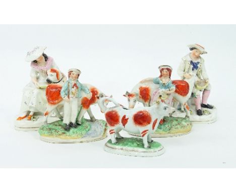 A pair of Staffordshire figures of a Shepherd and a girl with a dog, 20cm high and three Staffordshire cow figures/Provenance