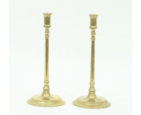 A pair of 18th Century brass coffee house candlesticks, with tall slender stem on a circular foot, 31cm high Condition Report