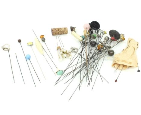 A collection of hat pins, including a 9ct gold turquoise bead hat pin by Murrle Bennett, a citrine single stone hat pin, two 