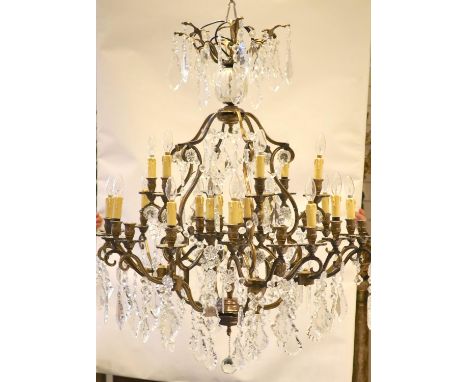 An 18th century style bronzed metal, cut glass 30 light chandelier by Christopher Wray, approximately 123 cm high