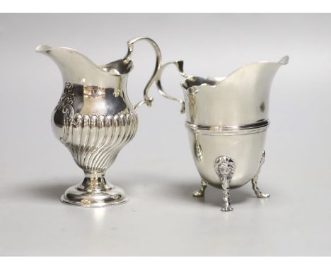 A late Victorian silver inverted pear shaped cream jug, Birmingham, 1894, 10.6cm, and a later silver cream jug, 8oz.