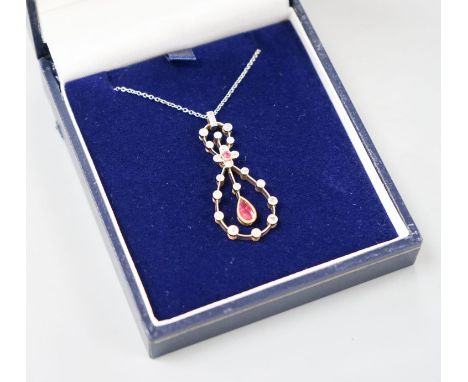 A modern 1920's style white metal, ruby and diamond set openwork oval drop pendant necklace, pendant 37mm, gross weight 6.1 g