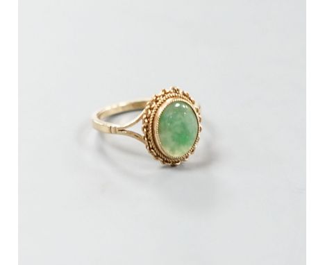 A 9ct gold and cabochon jade set oval ring, size M/N, gross weight 3 grams.